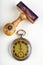 Old watch and wooden seal. Office accessories on a white sheet