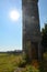 A old watchtower of a former GDR border fortification with a rusted door and sun