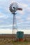 An old water pumping windmill with rainwater tank