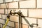 Old water tap with yellow hose, concept image