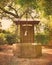Old water well with ornate iron scrollwork & bell