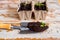 Old watering can with seedlings of flowers and vegetables on retro wooden background. Vintage home garden and planting