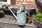 Old watering can and wooden kneading-trough