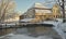 Old watermill, bringe un frozen river Aleksupite in snowy, sunny winter day, Kuldiga, Latvia