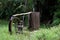 An old waterwheel in the middle of green vegetation, in the background tropical forest. Sao Paulo Botanical Garden