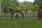 An old waterwheel in the middle of green vegetation, in the background tropical forest. Sao Paulo Botanical Garden