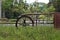 An old waterwheel in the middle of green vegetation, in the background tropical forest. Sao Paulo Botanical Garden