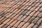 Old weather damaged roof tiles background