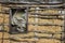 The old weathered adobe wall and wooden window.