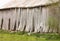 Old weathered barn with lifting boards and sloping roof