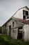 Old, Weathered Barn with Rusty Roof Lashed by Wind