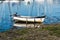 Old weathered boat moored on the beach in the marina