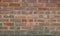 Old weathered brick wall in assorted coloured blocks with copy space