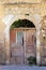 Old weathered broken wooden door, Greece