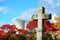 Old and weathered christian stone cross with a nuclear power plant in background