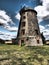 Old weathered and defunct wind mill in dramatic weather