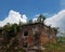 Old, weathered, dormant, overgrown red brick castle