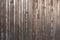 Old weathered faded barn wall made from vertically oriented wood planks. Vintage rustic timber background. Lumber texture