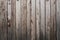 Old weathered faded shed wall made from vertically oriented wood boards. Vintage rustic textured timber background. Lumber texture