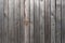 Old weathered faded shed wall made from vertically oriented wood planks. Vintage rustic textured timber background. Timber texture