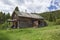 Old weathered farmhouse cabin mountains grass