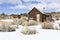 Old weathered Ghost Town buildings in the desert during winter with snow.