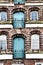 Old weathered and rough facade of a medieval bakery with blue doors in the Hanseatic city of LÃ¼neburg