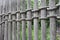 Old weathered rustic wooden fence secured with thick heavy rope