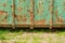 Old weathered and rusty green iron container on the ground