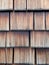 Old weathered shingles. Vertical close up, wooden texture, background for design and decoration.