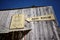 Old weathered timber clad building with bank sign