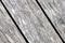 Old weathered washed tainted wood texture with diagonal cracks and twig. Natural textured closeup dry plank background.