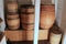 Old weathered wine barrels set in closet on wood shelving