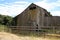 Old, weathered wooden barn stands abandoned, Garland Ranch, Carmel Valley, CA.