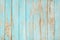 Old weathered wooden plank painted in turquoise blue color.