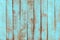 Old weathered wooden plank painted in turquoise blue pastel color