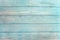 Old weathered wooden plank painted in turquoise or blue sea color