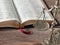 Old weighing scale balance on wooden table with Holy Bible Book in the background