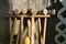 Old well-used Croquet Mallets in a rack leaning against a wooden wall, medium shot