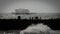 The old West Pier of Brighton, England, UK with the silhouette of donut groyne