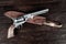 Old west weapon. Colt Revolver and knife with holster on deck