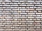 Old wet brick wall with devastating bricks. Brick surface as background, empty brick wall texture.
