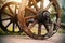 Old wheels of a vintage wooden cart that stands in the village on a road on a summer day. Village transport of movement. History