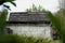 Old white abandoned house with hole in roof