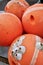 Old white barnacles on orange buoys