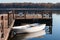 Old white boat with blue oars near the wooden pier