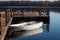 Old white boat with blue oars near the wooden pier