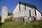 Old white deteriorating barn and silo