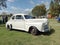 Old white late 1940s Ford V8 Super Deluxe coupe on the lawn