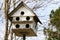 Old white multiple hole rural country birdhouse